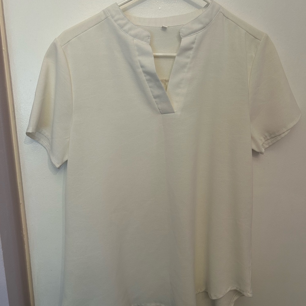 Two womens blouses in cream and burnt orange